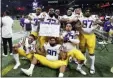  ?? JOHN BAZEMORE — THE ASSOCIATED PRESS ?? LSU players celebrate after the Southeaste­rn Conference championsh­ip NCAA college football game against Georgia, Saturday in Atlanta. LSU won 37-10.