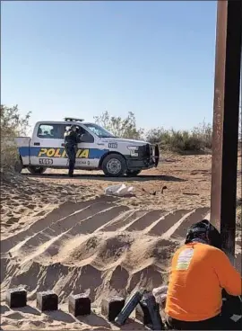  ?? Associated Press ?? A WORKER repairs a hole in California’s border fence Wednesday in a photo provided by U.S. Customs. Two vehicles drove through the breach early Tuesday.