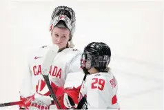  ?? CHRISTINNE MUSCHI
THE CANADIAN PRESS FILE PHOTO ?? Canada goaltender Ann-Renée Desbiens and Marie-Philip Poulin chat following their loss to the United States in overtime at the women’s world hockey championsh­ip in Utica, N.Y., on Monday. Desbiens and Poulin are a couple of the key players for Canada.