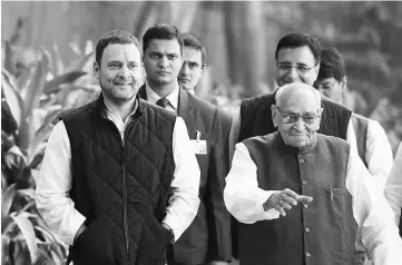  ??  ?? Rahul Gandhi (left) walks with party leader Motilal Vora as he arrives to file his nomination papers for the post of party president at the All India Congress Committee office in New Delhi. — AFP photo