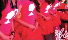  ??  ?? Waitresses stand in their uniforms during the opening ceremony of a Barbiethem­ed restaurant in Taipei.