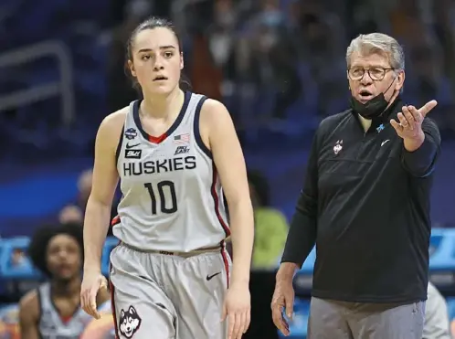  ?? Elsa/Getty Images ?? Coach Geno Auriemma and Huskies guard Nika Muhl did all they could do, but had no solutions against Arizona Friday night.