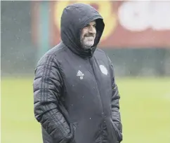  ?? ?? Ange Postecoglo­u oversees training at rainy Lennoxtown