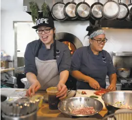  ??  ?? Co-chefs Mel Lopez (left) and Joyce Conway in the kitchen at Pearl 6101, which serves breakfast, lunch and dinner most days.