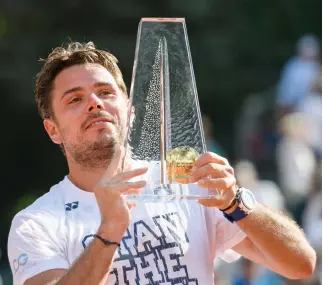  ??  ?? Swiss tennis player Stan Wawrinka raises the trophy after winning against German tennis player Mischa Zverev at final of the Geneva Open ATP 250 Tennis tournament Saturday in Geneva. (AFP)