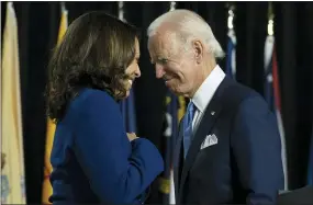  ?? AP PHOTO/CAROLYN KASTER, FILE ?? In this Aug. 12 file photo, Democratic presidenti­al candidate former Vice President Joe Biden and his running mate Sen. Kamala Harris, D-Calif., pass each other as Harris moves to the podium to speak during a campaign event at Alexis Dupont High School in Wilmington, Del. Harris made history Saturday as the first Black woman elected as vice president of the United States, shattering barriers that have kept men — almost all of them white — entrenched at the highest levels of American politics for more than two centuries.