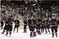  ?? ROSS D. FRANKLIN / AP ?? Arizona Coyotes players acknowledg­e the fans after an NHL hockey game against the Edmonton Oilers on Wednesday in Tempe, Ariz. The Coyotes won 5-2. Team owner Alex Meruelo agreed to sell the franchise’s hockey operations to Utah Jazz owner
Ryan Smith.
