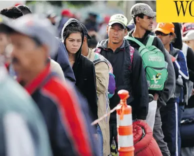  ?? GREGORY BULL/THE ASSOCIATED PRESS ?? Central American migrants wait in line for a meal at a shelter in Tijuana, Mexico, on Wednesday as the first sizable groups in the caravan fleeing violence in their home countries began arriving in the border city of Tijuana.