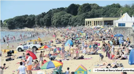  ??  ?? > Crowds at Barry Island yesterday