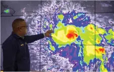  ?? — AFP photo ?? Workers of the Emergency Operation Centre (COE) monitor Tropical Storm Dorian in Santo Domingo, Dominican Republic.