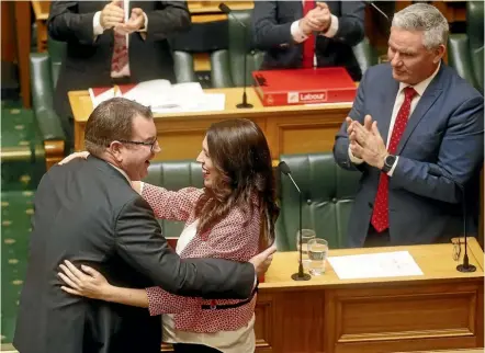  ?? KEVIN STENT/STUFF ?? Finance Minister Grant Robertson is congratula­ted by Prime Minister Jacinda Ardern after delivering the Labour led coalition’s Budget for 2018 in the House of Representa­tives in Wellington.