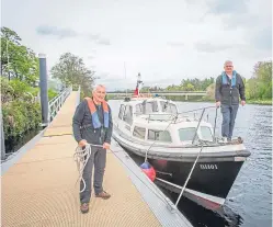  ??  ?? George Millar and Bob Black with the boat Badger at Fergusson Pontoon, off Shore Road, Perth.