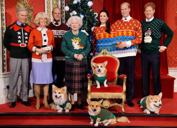  ??  ?? ALTERNATE REALITY: Wax models of the British royal family wear Christmas jumpers in a display at Madame Tussauds in London