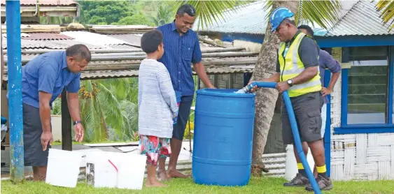  ?? Photo: Kelera Sovasiga ?? Residents of Wailoku have their drums and buckets filled by water carting trucks provided by the Water Authority of Fiji on April 24, 2020.