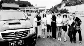 ??  ?? The convoy participan­ts with some of the friendly Chinese they met in Sichuan Gansu yesterday.