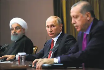  ?? Mikhail Klimentyev / AFP / Getty Images ?? Russian President Vladimir Putin (center), Turkish President Recep Tayyip Erdogan, right, and Iranian President Hassan Rouhani address a trilateral meeting on Syria in Sochi, Russia.