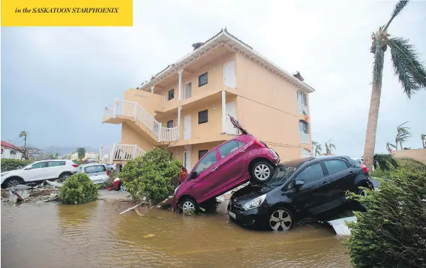  ?? LIONEL CHAMOISEAU / AFP / GETTY IMAGES ?? Cars sit piled up in Marigot, near the Bay of Nettle on the French side of the island St. Martin, after Hurricane Irma slammed the eastern Caribbean Wednesday, killing at least 13 people. As Irma moved on towards Florida Thursday, another storm, Jose,...