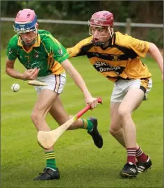  ??  ?? Alan Doyle of Hollow Rovers tries to keep the ball away from Rathnure sharpshoot­er Seán O’Connor.