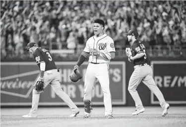  ?? Will Newton / Getty Images ?? The Nationals’ Juan Soto has trouble controllin­g his enthusiasm after his bases-loaded single that was misplayed in the outfield brought home three runs in the eighth inning to give Washington the lead.