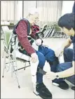  ?? (AFP) ?? This file picture, taken on Oct 26, 2011 shows Emiko Tsunematsu, 84, paralyzed on her left side, wearing a robot suit HAL (Hybrid Assistive Limb) as she trains for walking in Takasaki, Gunma prefecture, 100 kms north of
Tokyo, Japan.