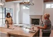  ?? Photos by Jon Shapley / Staff photograph­er ?? Top: Realtor Charlie Neath and co-worker Jennifer Marriott bump elbows during a June 4 open house. Above: Realtor Gordana Vickers, left, and Joyce Janse speak during an open house in Briargrove.