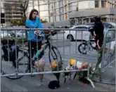  ?? SHANNON STAPLETON / REUTERS ?? Kate Anstett, 22, wipes tears from her eyes by a makeshift memorial for victims of Tuesday’s terrorist attack outside a police barricade on the bike path in New York.