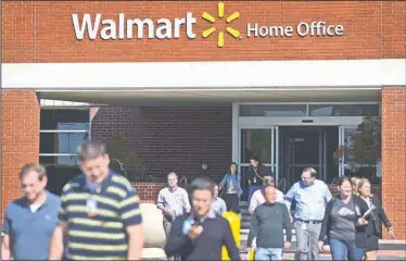  ?? NWA Democrat-Gazette/BEN GOFF • @NWABENGOFF ?? People come and go on Friday at the Wal-Mart Home Office in Bentonvill­e. Wal-Mart Stores, Inc. announced that 450 of the retailer’s roughly 18,000 home office employees were let go on Friday.