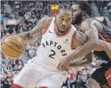  ?? CHRIS YOUNG THE CANADIAN PRESS ?? Toronto Raptors’ Kawhi Leonard, left, drives at Miami Heat’s Justise Winslow in National Basketball Associatio­n action in Toronto on Sunday. Leonard scored 29 points and had 10 rebounds in a 125-115 Toronto win. For complete coverage, see the record.com.