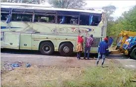  ??  ?? Workers remove the branding from the Bravo bus which crashed yesterday