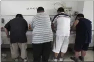  ?? THE ASSOCIATED PRESS ?? In this Thursday, July 24, 2008 file photo, obese patients wash their plates after lunch at the Aimin Fat Reduction Hospital in Tianjin, China. The hospital uses a combinatio­n of diet, exercise and traditiona­l Chinese acupunctur­e to treat rising...