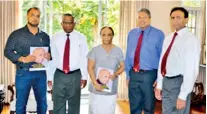  ??  ?? Handing over the special issue of Profession­al Manager to Mrs. Weerasoori­a and his son Senaka Weerasoori­a by Prof. Ajantha S. Dharmasiri, accompanie­d by K.A.I. Kalyanarat­ne, Management Consultant and Jayantha Ranapura, Senior Assistant Registrar, PIM