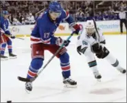  ?? MARY ALTAFFER - THE ASSOCIATED PRESS ?? New York Rangers right wing Jesper Fast (17) and San Jose Sharks center Melker Karlsson (68) chase a loose puck during the third period of an NHL hockey game, Thursday, Oct. 11, 2018, at Madison Square Garden in New York. The Rangers won 3-2.