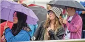  ?? ALEX GOULD/THE REPUBLIC ?? Carly Golisch enjoys the music in the rain as Pariah Pete performs on the Ronstadt stage during day one of the ZONA Music Festival at Margaret T. Hance Park on Saturday.