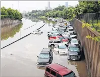  ?? AP PHOTO ?? Vehicles are shown stranded by massive flooding in Houston from the effects of Hurricane Harvey.