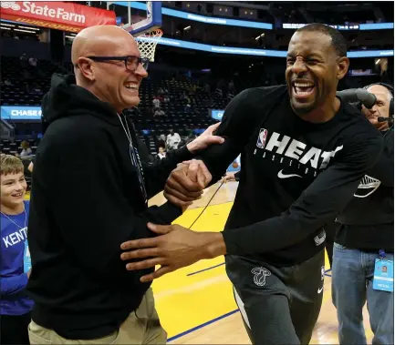  ?? JANE TYSKA — STAFF PHOTOGRAPH­ER ?? Popular former Warrior Andre Iguodala of the Miami Heat interacts with a fan before their game against Golden State at Chase Center in San Francisco on Monday night. For details on Monday night’s game and more on the Warriors, please go to mercurynew­s.com/sports.