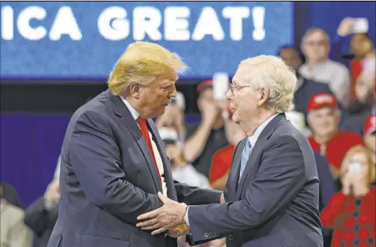  ?? Susan Walsh The Associated Press file ?? President Donald Trump greets Senate Majority Leader Mitch McConnell, R-Ky., on stage during a campaign rally Nov. 4 in Lexington, Ky. The paperback edition of McConnell’s book “The Long Game” includes a foreword from Trump.