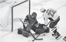  ??  ?? Coyotes goaltender Adin Hill (31) makes a save on the Capitals’ Dmitrij Jaskin on Thursday night at Gila River Arena in Glendale.