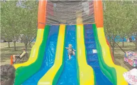  ??  ?? Nathaniel Osofsky goes down a giant slide Sunday at the Taste of Chicago.