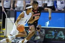  ?? GEORGE FREY — THE ASSOCIATED PRESS ?? BYU guard Trey Stewart, left, drives on Denver guard Isaiah Addo- Ankrah during the first half Wednesday in Provo, Utah.