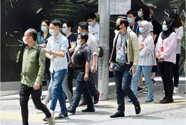  ??  ?? SOP compliance: Pedestrian­s wearing masks crossing a street in Bukit Bintang. With the seven new cases detected, the total number of active cases in the country is now 184.