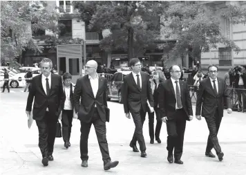  ?? ASSOCIATED PRESS ?? Fired Catalan Cabinet members arrive at the national court in Madrid, Spain, as some of the 14-member ousted Catalan cabinet were expected to appear before a judge in Madrid.