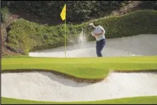  ?? Associated Press ?? Scottie Scheffler hits from the bunker on the 12th hole during the first round at the Masters golf tournament at Augusta National Golf Club, Thursday, in Augusta, Ga.