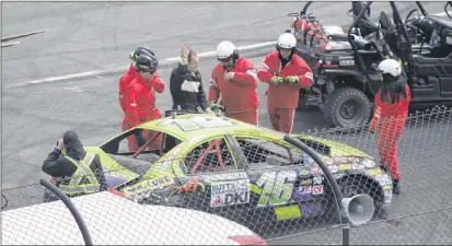  ?? SAM MCNEISH/THE TELEGRAM ?? Andrew Morgan, driver of the No. 16 Atlantic Dodge Dealers Hobby Stock Division entry, waves to the crowd after safety officials help him climb out of his car that barrel-rolled several times at the start/finish line on the final lap of his race on Sunday at Eastbound Speedway.