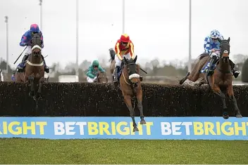  ?? ALAN CROWHURST/GETTY IMAGES ?? Double Shuffle (right) is saddled by Tom George in the Charlie Hall Chase at Wetherby