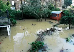  ??  ?? From top: gardens submerged in flood waters; Cressida’s stripped-out kitchen and hallway