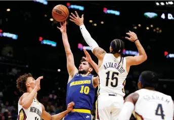  ?? — AFP file photo ?? Ty Jerome (left) of the Golden State Warriors shoots over Jose Alvarado #15 of the New Orleans Pelicans during the fourth quarter of an NBA game at Smoothie King Centre in New Orleans, Louisiana.