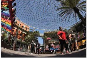  ?? (AP/Mark J. Terrill) ?? People walk through Universal CityWalk near Universal City, Calif., last week.