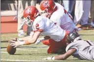  ?? Dave Stewart / Hearst Connecticu­t Media ?? New Canaan's Jack Finnigan (2) dives to recover a Stamford fumble at Boyle Stadium on Saturday.