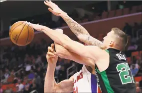  ?? Duane Burleson / Associated Press ?? Celtics forward Daniel Theis defends against a shot by Detroit Pistons center Boban Marjanovic during Boston’s 91-81 victory Sunday in Detroit.