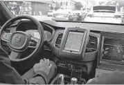  ?? Eric Risberg / Associated Press file ?? An Uber self-driving car waits in traffic in San Francisco. “It’s hard to program in human stupidity,” says a spokesman for an autonomous car unit.